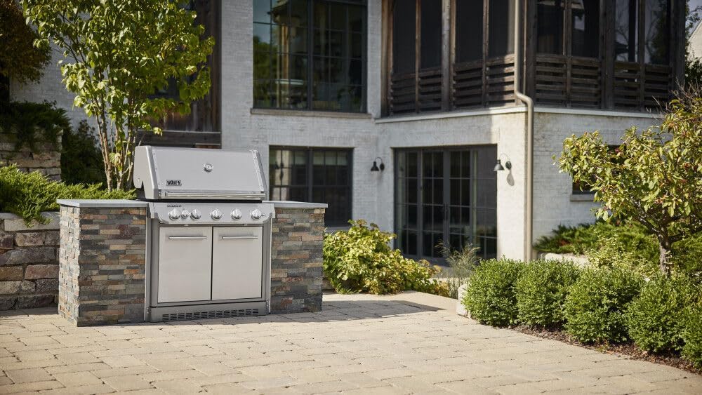 Weber Summit SB38 S Built-In Natural Gas Grill integrated into a stone outdoor kitchen on a patio.