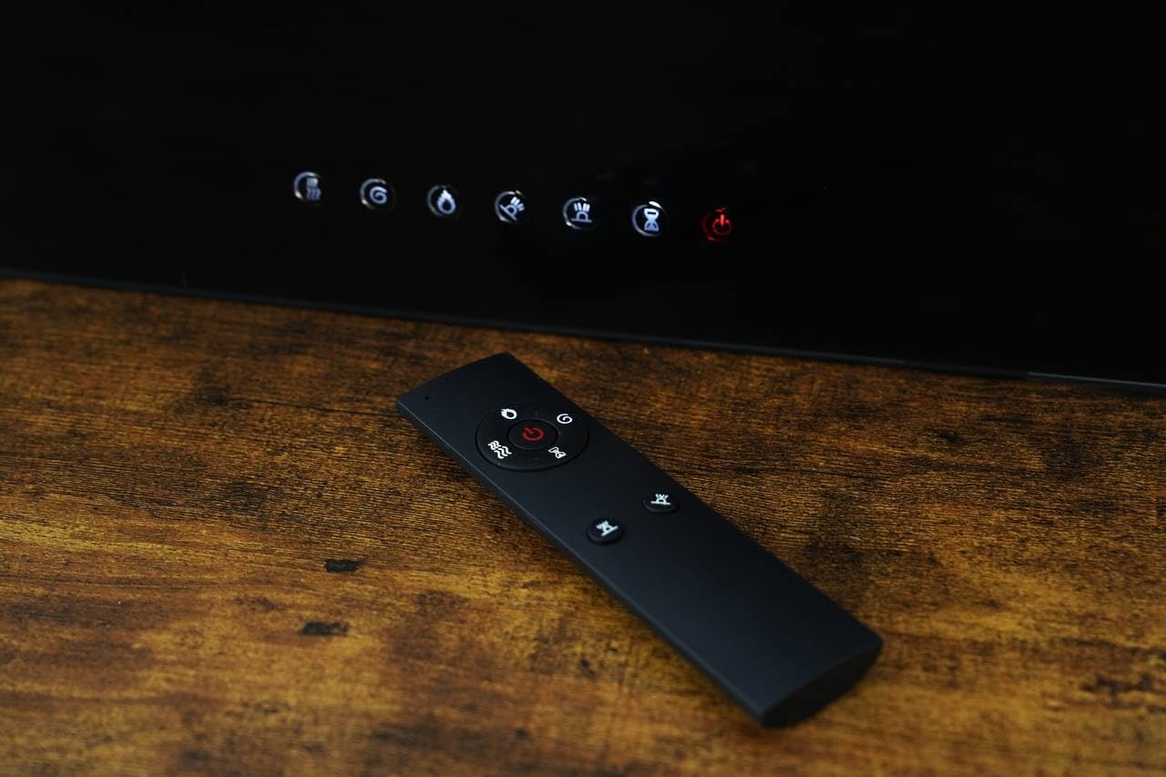 Close-up view of the remote control for the Mystflame electric fireplace.