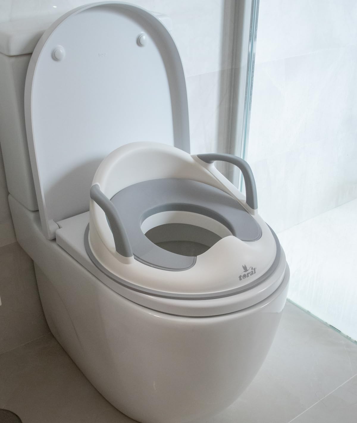 Toral Asiento Reductor con Asas para WC. Ayuda al aprendizaje de bebés y niños. Adaptador infantil portátil para váter MundiBebé +18 meses. Modelo Comfort