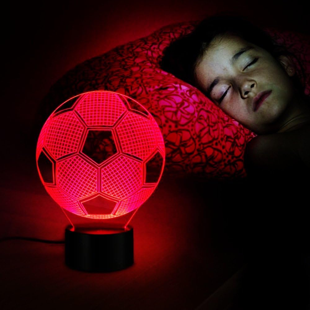 Child sleeping with the WANTASTE 3D Soccer Ball Night Light emitting a red glow