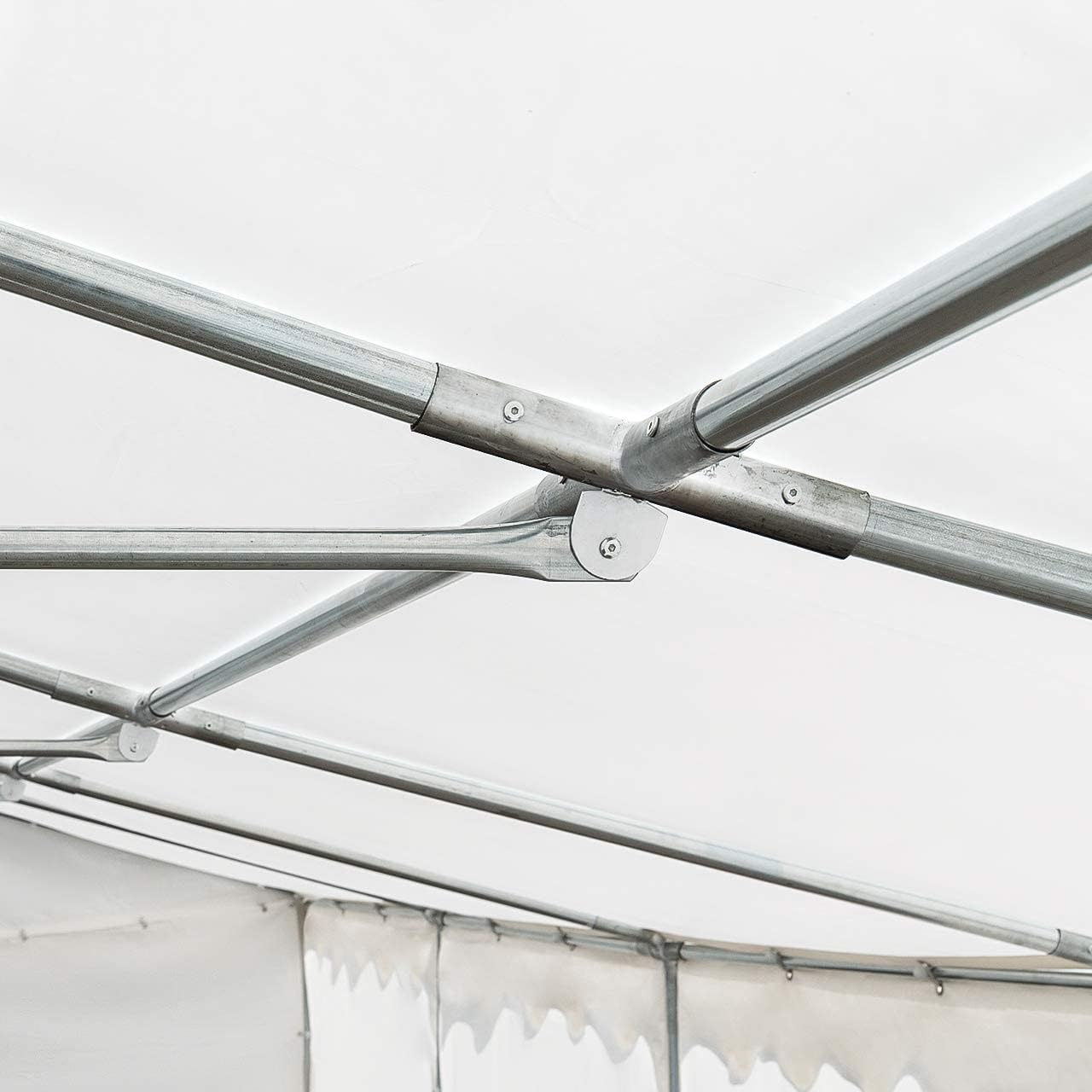 Close-up of a roof frame connection point, showing multiple steel poles joined by a connector.
