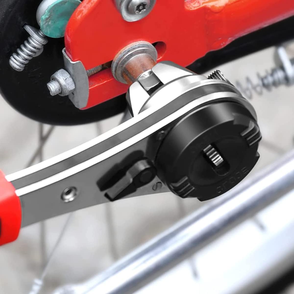 Ghopy Adjustable Ratchet Wrench being used to tighten a bolt on a bicycle wheel.