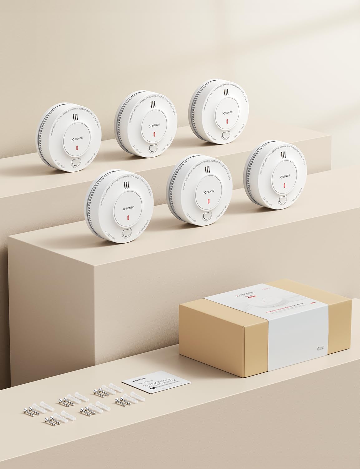Contents of the X-Sense smoke detector 6-pack, including alarms, manual, screws, and anchor plugs.