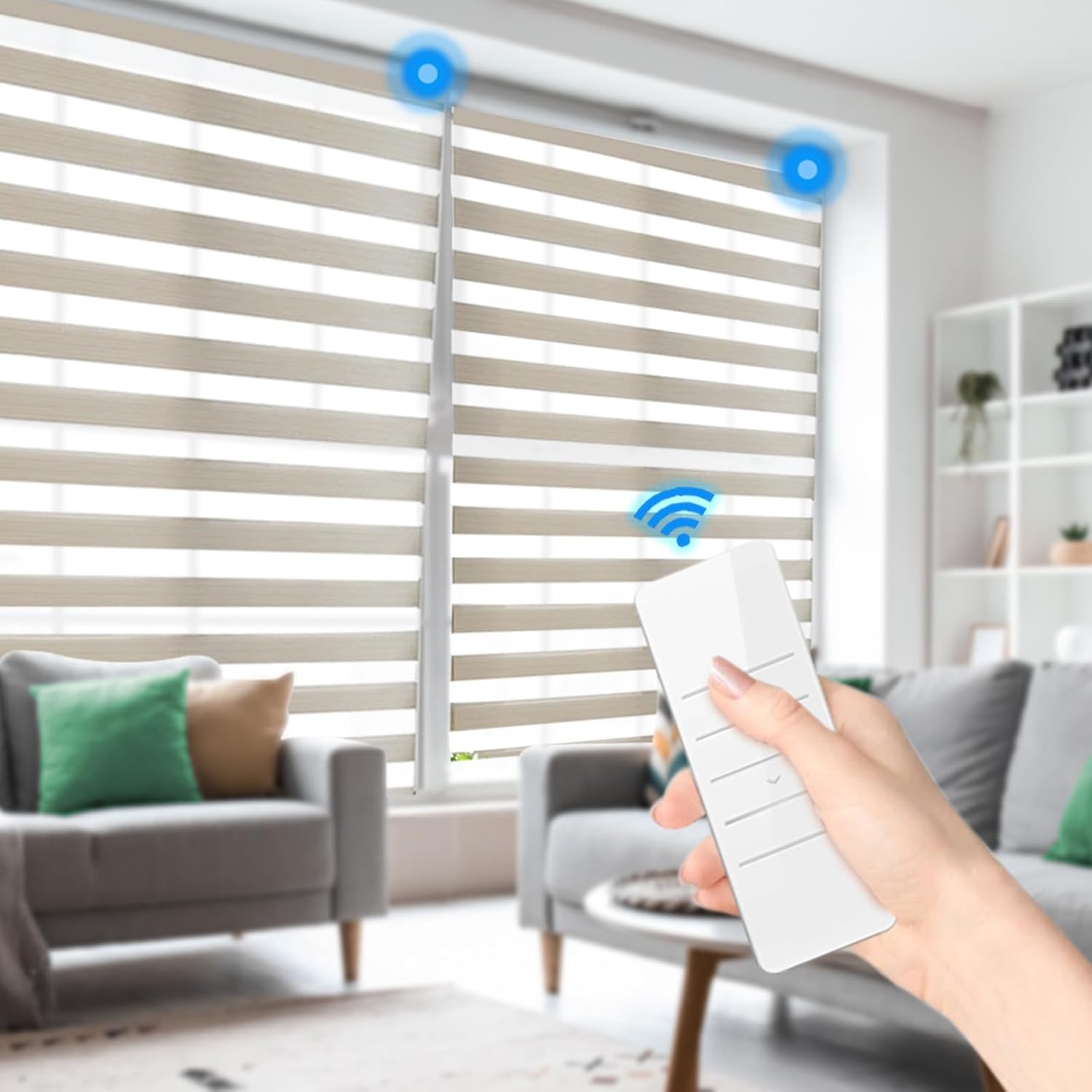A hand holding the white remote control, pointing towards two motorized window blinds in a living room, with blue light indicators showing the blinds are receiving signals.