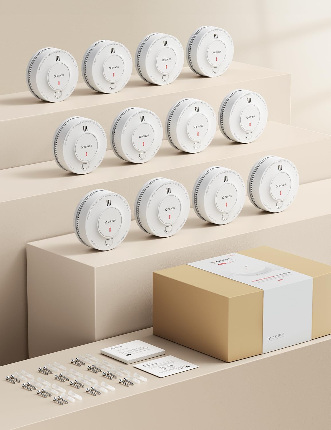 Contents of the X-Sense smoke detector package, showing multiple detectors, screws, and manuals.