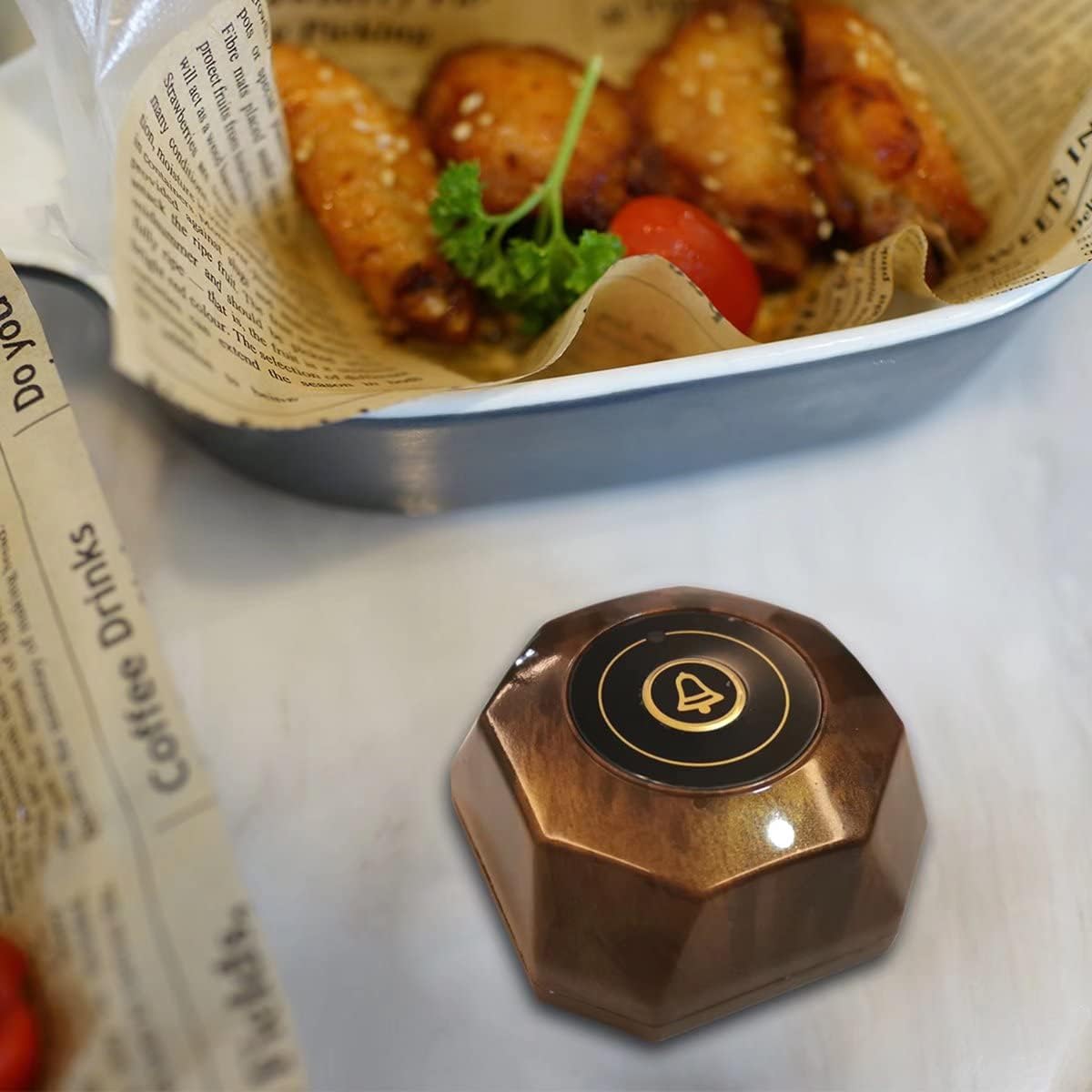 Close-up of a FLYDOG call button next to a plate of food
