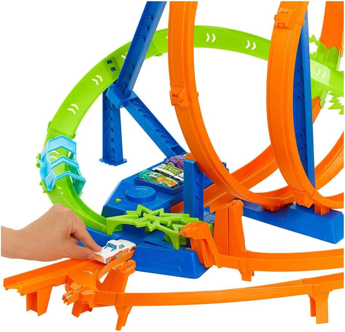 A child's hand placing a Hot Wheels car onto the track, demonstrating the start of play.