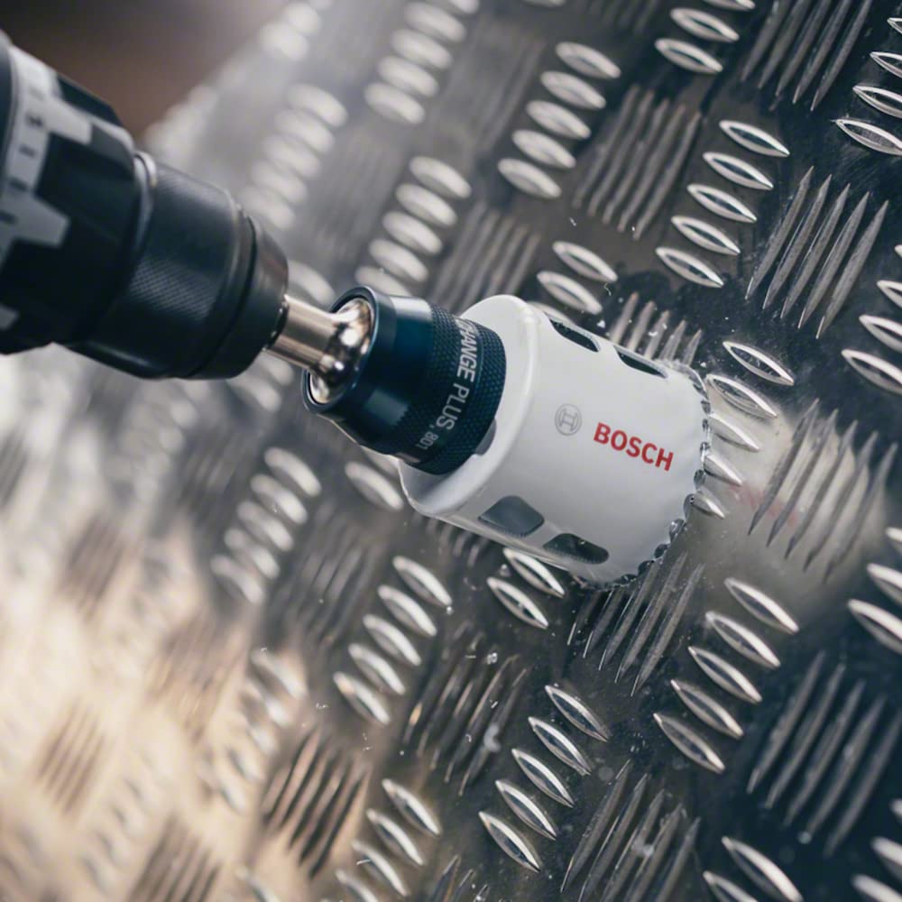 Drill with Bosch Power Change Plus Adapter and hole saw cutting into metal