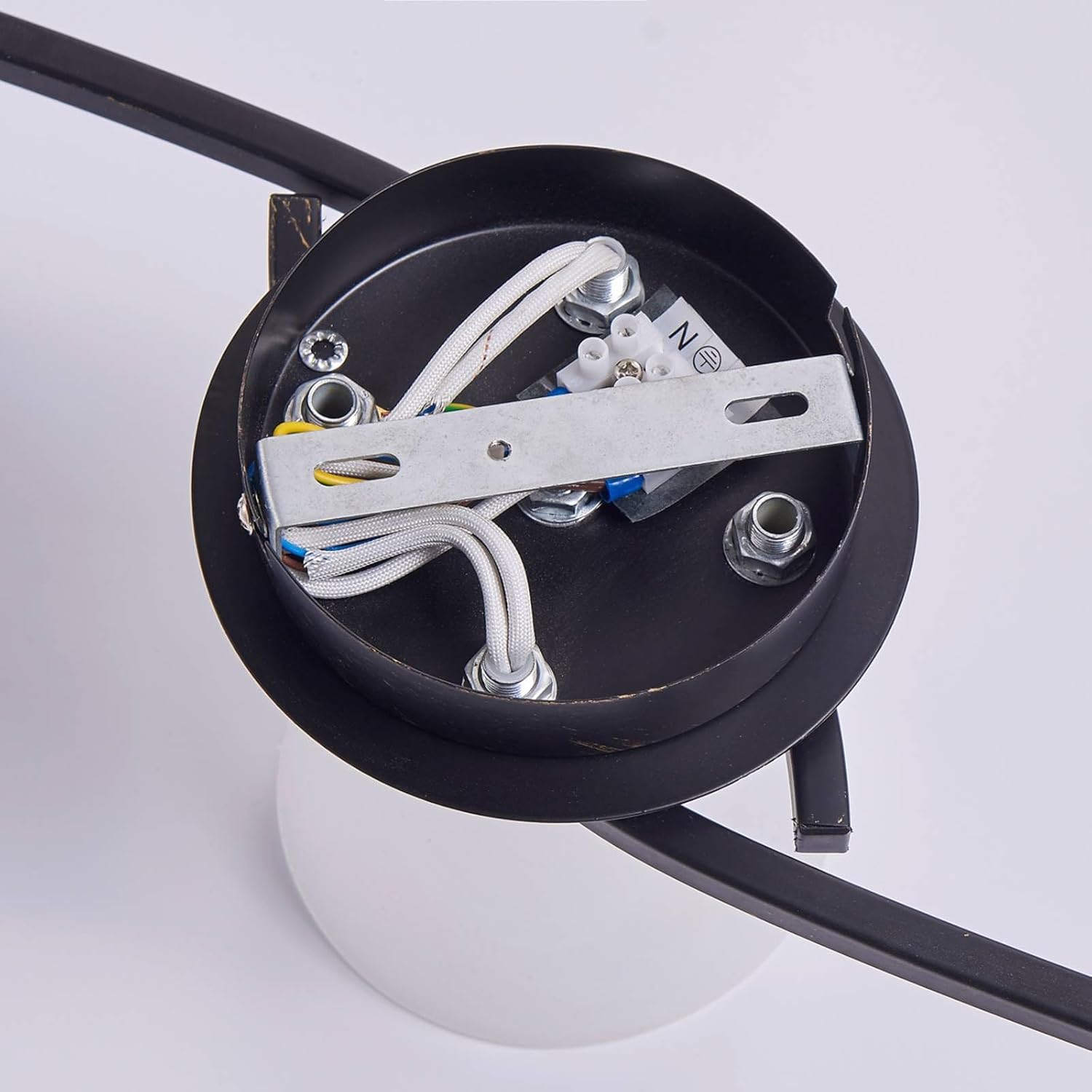 Close-up view of the electrical wiring connections inside the ceiling light's mounting base