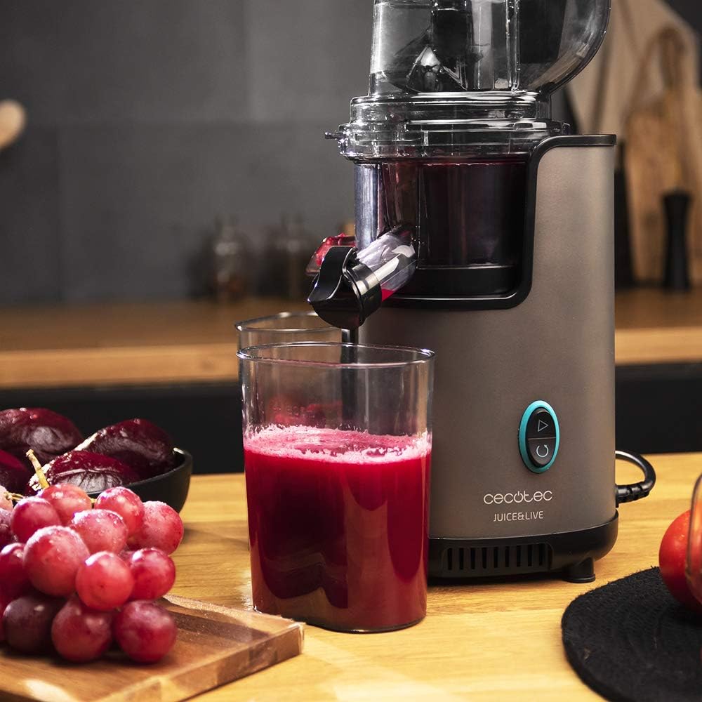 Cecotec Juice&Live 2500 EasyClean juicer extracting red juice from grapes and beets.