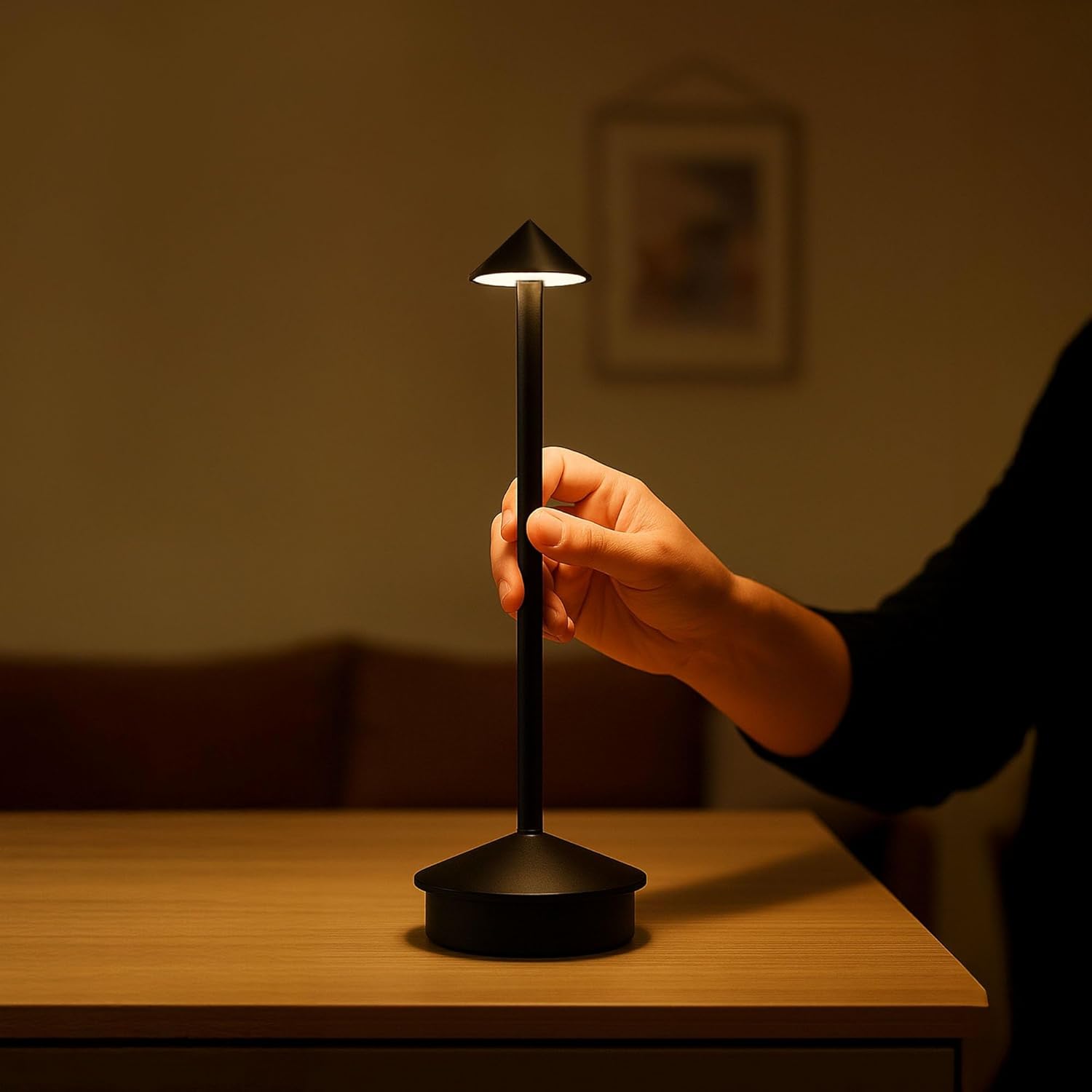 Hand holding the Ledvion lamp, demonstrating its portability