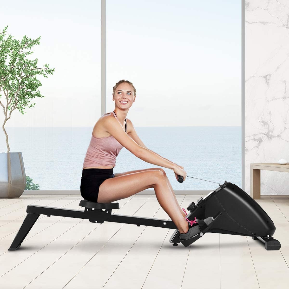 Dona demostrant la tècnica correcta de rem a la màquina de rem GYMAX