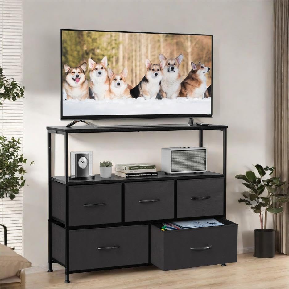 Assembled GlasFlength TV Stand with a television on top and five fabric drawers below.