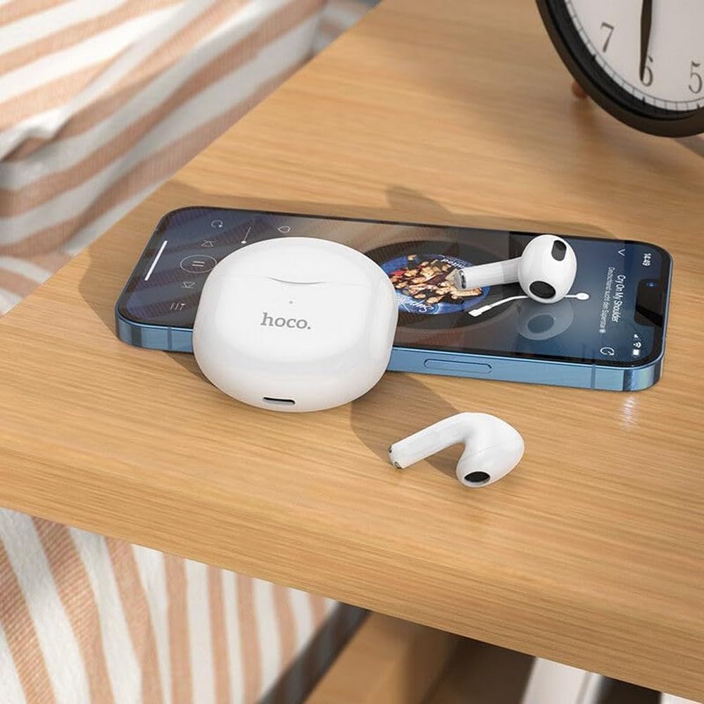 Hoco EW35 Earphones and charging case next to a smartphone playing music