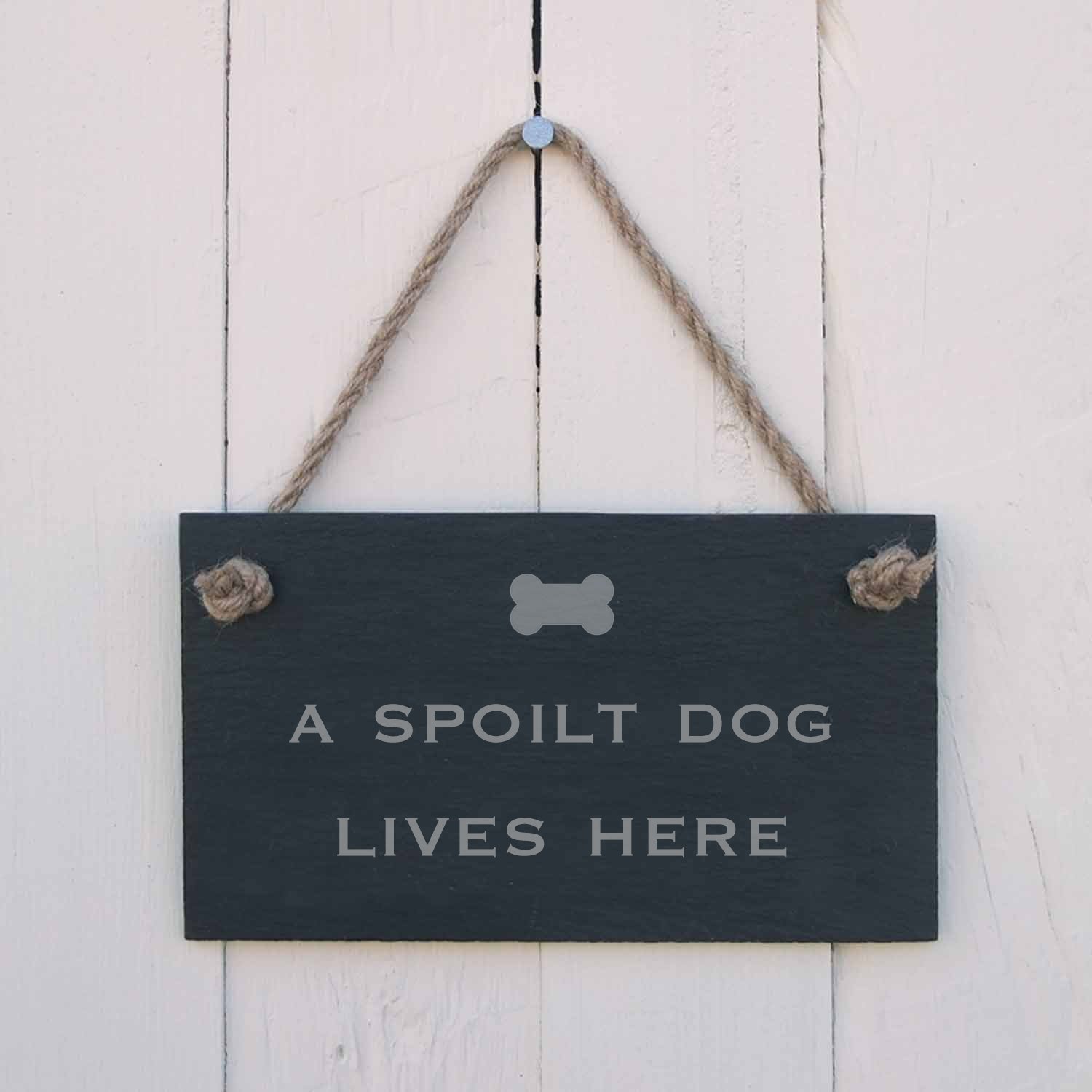 'A spoilt dog lives here' Slate Hanging Sign