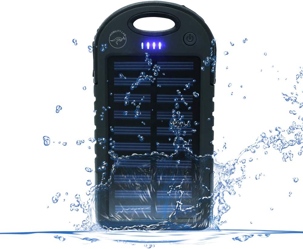 MOBILITY LAB ML311210 Solar Power Bank being splashed with water, demonstrating its IPX4 water resistance.