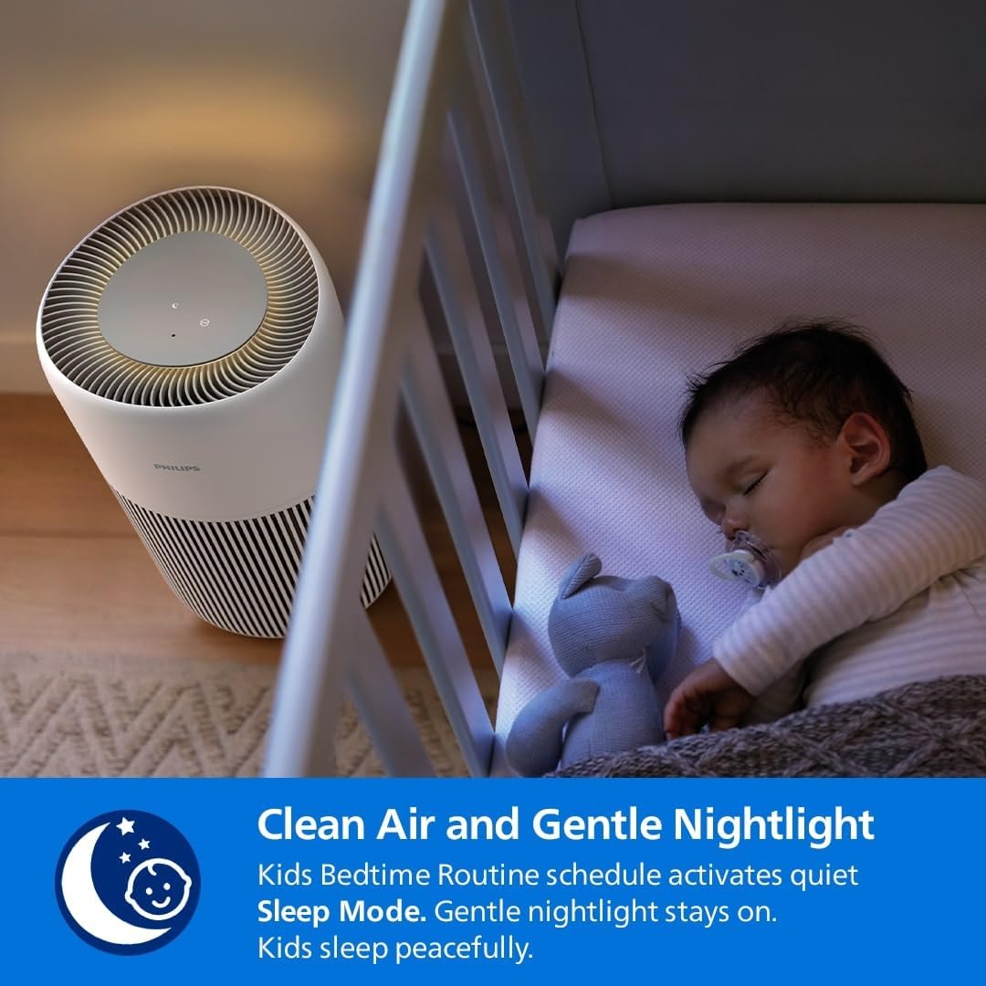 Philips air purifier next to a baby's crib with a gentle nightlight