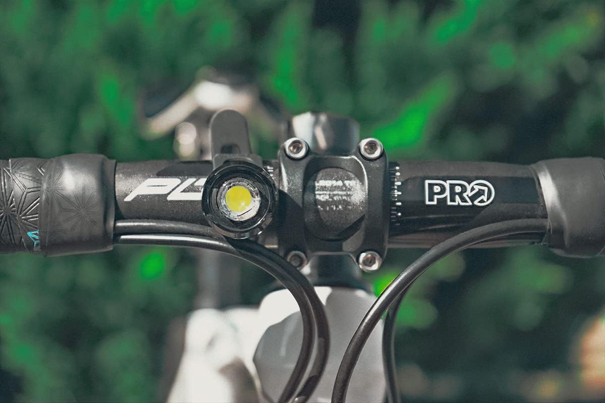 CATEYE ORB light showing its bright LED on a handlebar