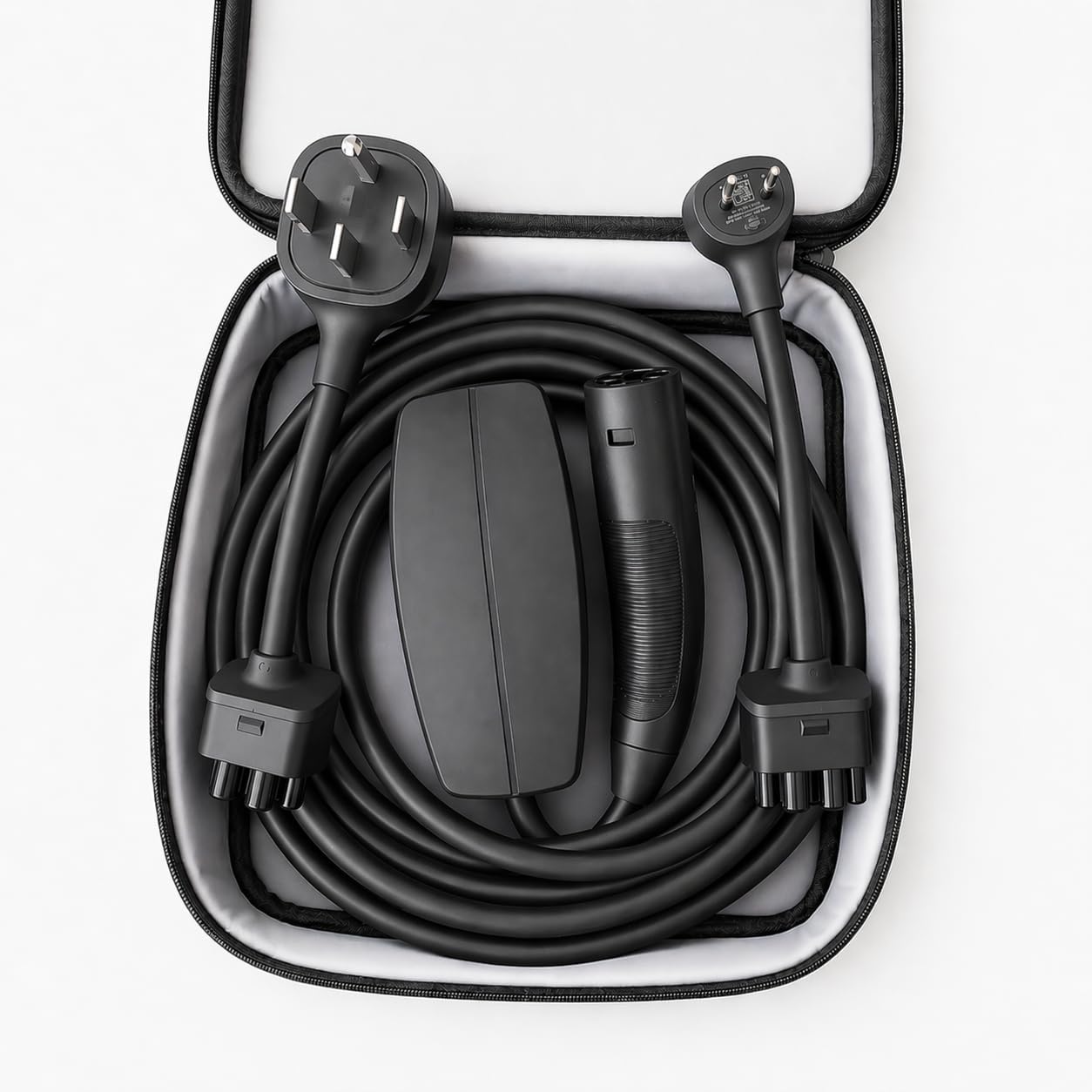 Tesla Mobile Connector and adapters stored in a black carrying bag
