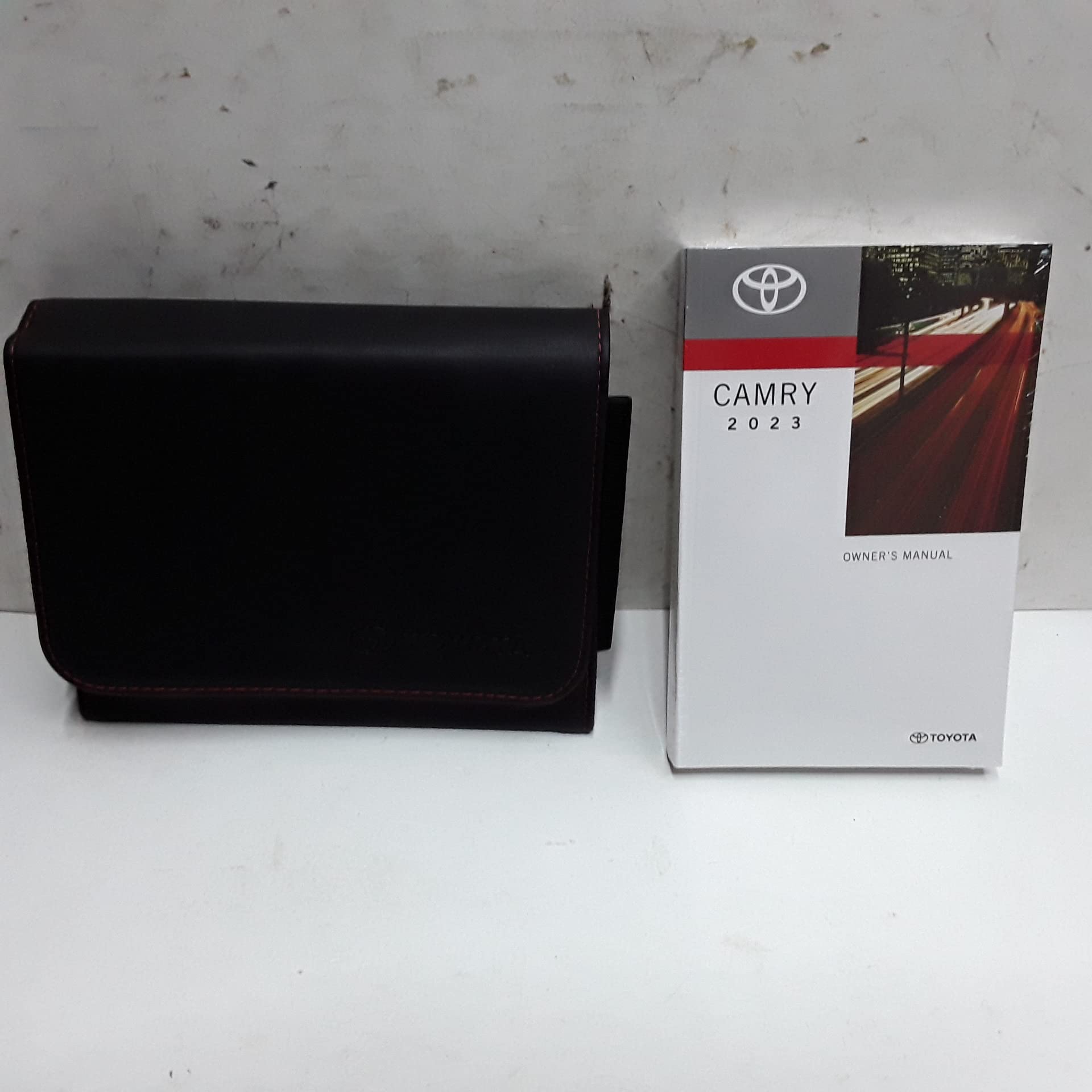 2023 Toyota Camry Owner's Manual and a black protective case