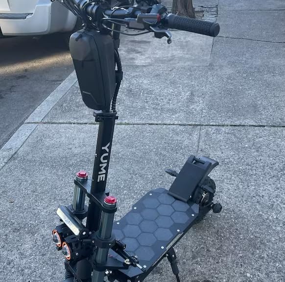 Electric scooter with the footrest installed, viewed from the front-right, showing the overall aesthetic.