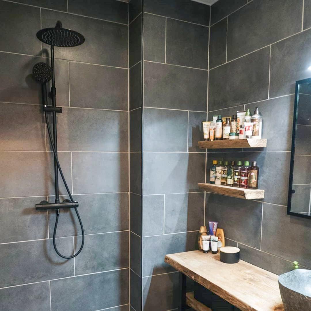 Close-up of the handheld shower head on the ESSEBAGNO Kissy Shower Column