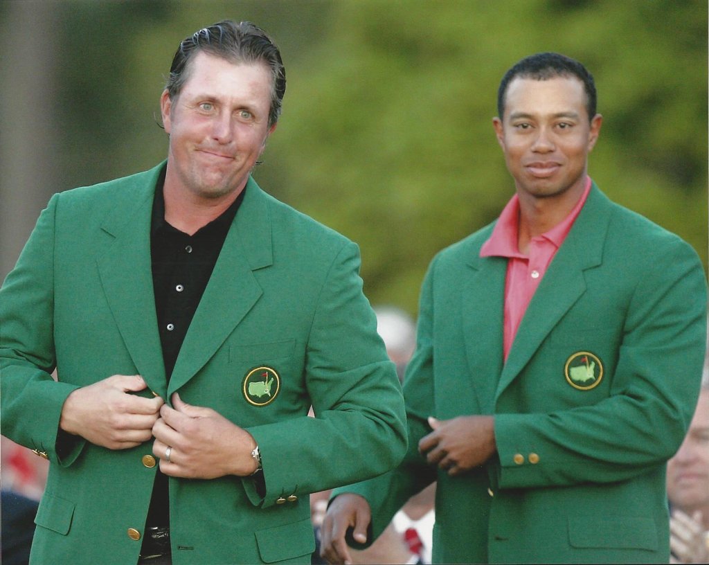 Phil Mickelson, left, gets his Masters Green Jacket from last years winner Tiger Woods after winning the 2006 Masters tournament at the Augusta National Club in Augusta, Ga., in this April 9, 2006 Photo Picture
