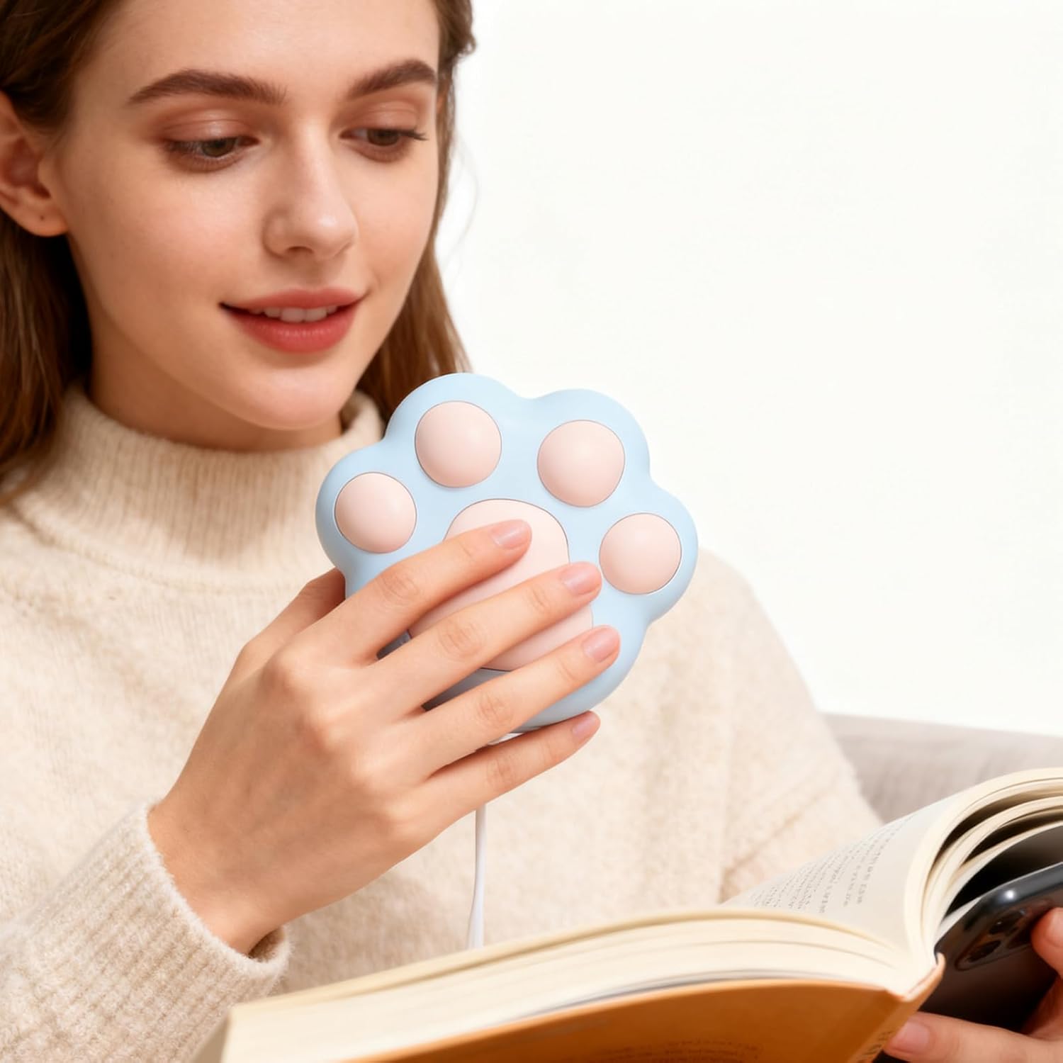 Cat paw hand warmer showing size in hand