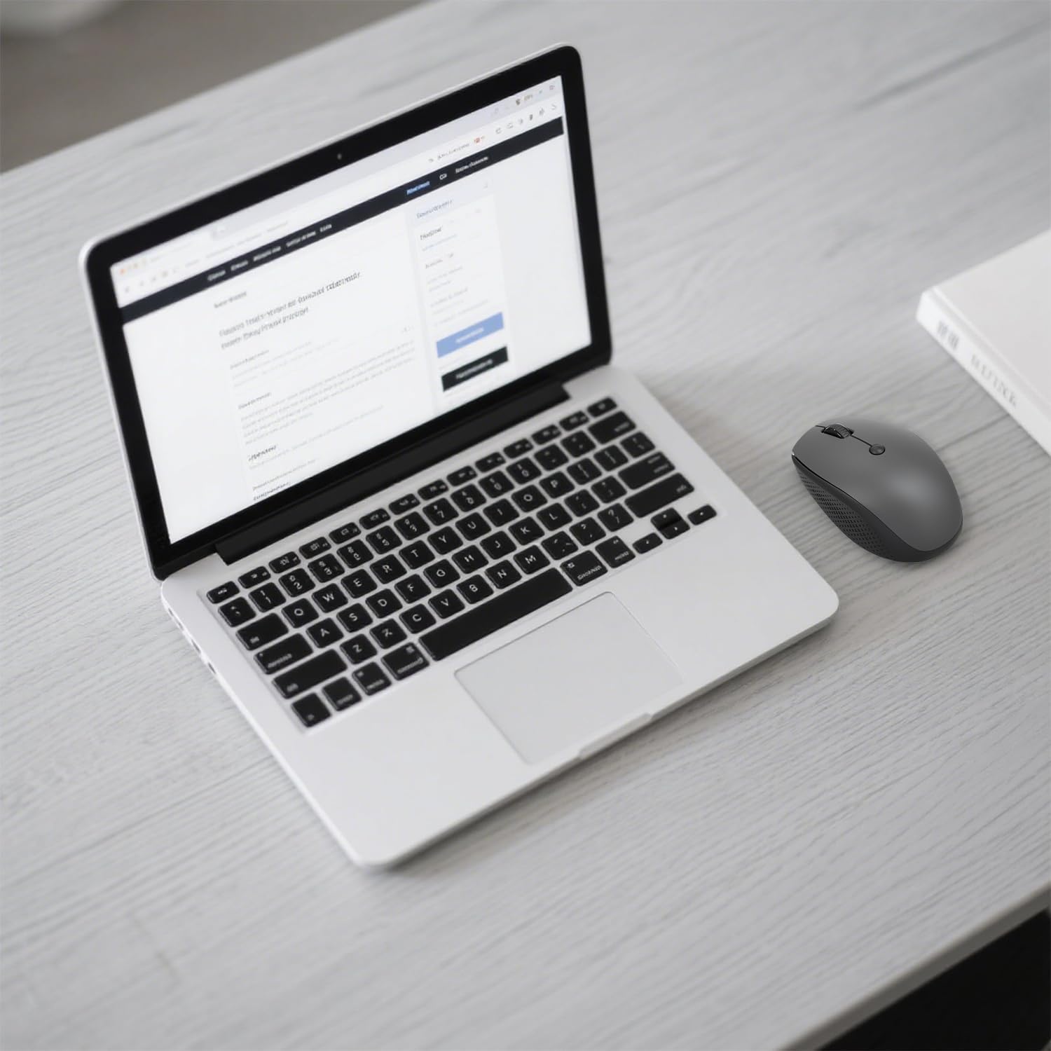 MKE 411 mouse next to a laptop, demonstrating wireless connectivity