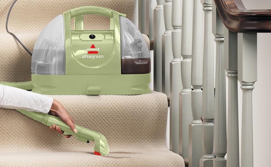 Person cleaning carpeted stairs with the BISSELL Little Green cleaner