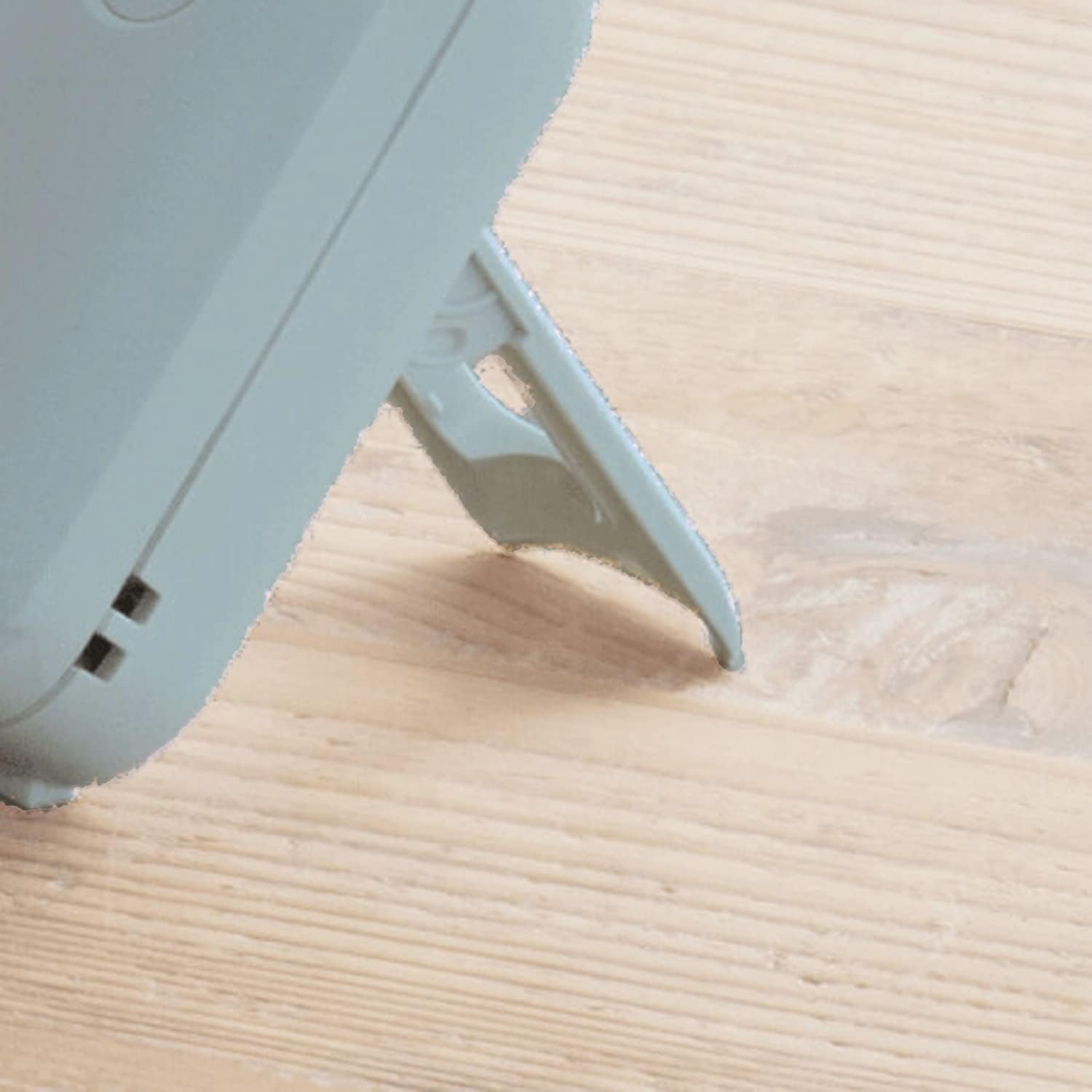 Close-up view of the fan's stand resting on a surface