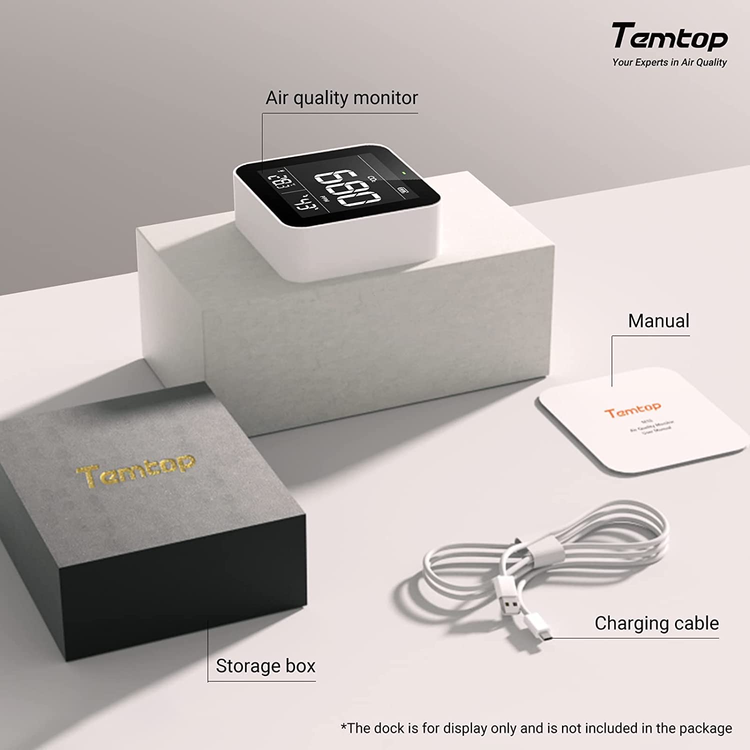 Contents of the Temtop C10 package: the monitor, manual, charging cable, and storage box.