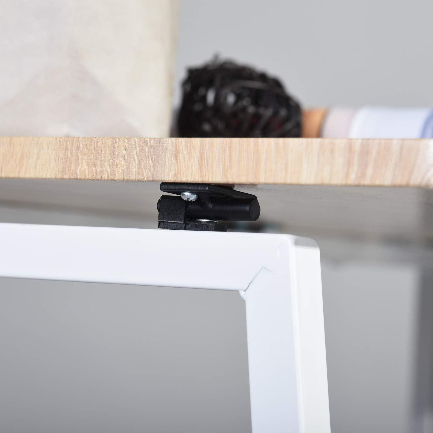 Close-up of the black widget mechanism underneath the Homy Casa desk desktop, designed to stabilize the desk and prevent shaking.