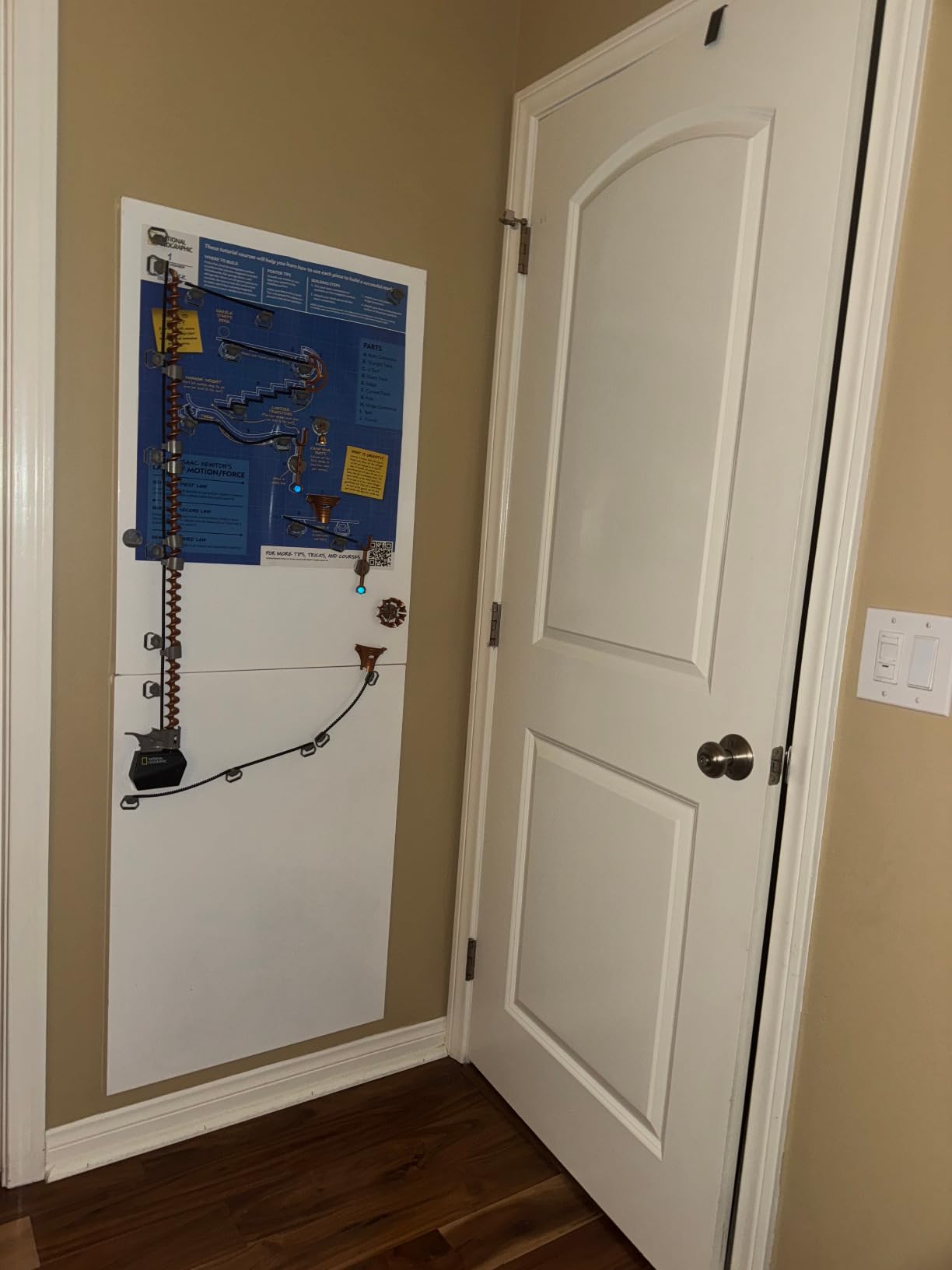 Close up of magnetic marble run pieces showing the track connectors and trick elements