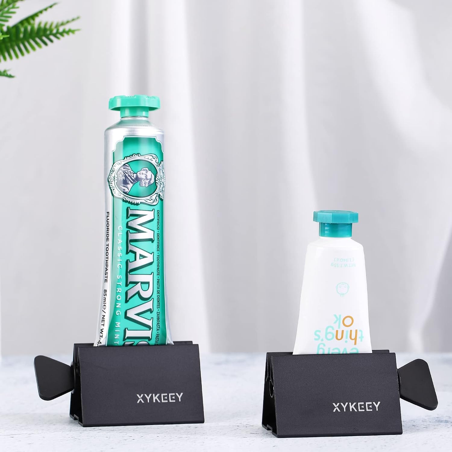XYKEEY Toothpaste Tube Squeezer - Set of 2 Toothpaste Squeezer Rollers, Metal Toothpaste Tube Wringer Seat Holder Stand (Black)