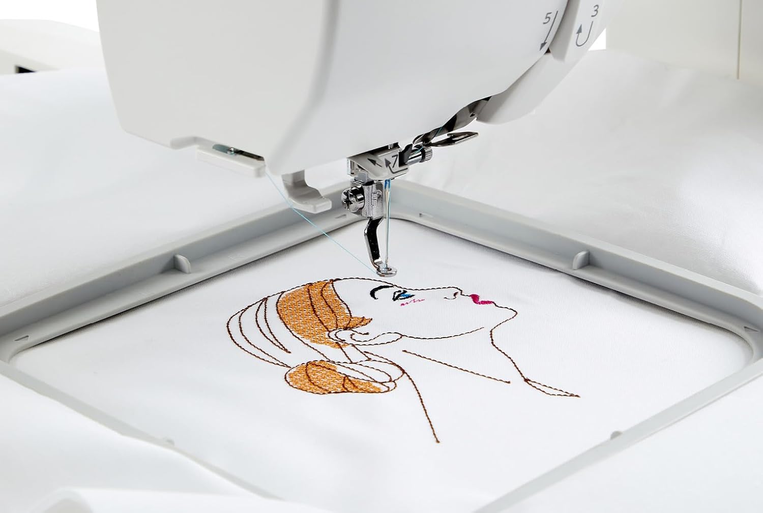 Close-up of the Janome Memory Craft 100E actively embroidering a design on fabric