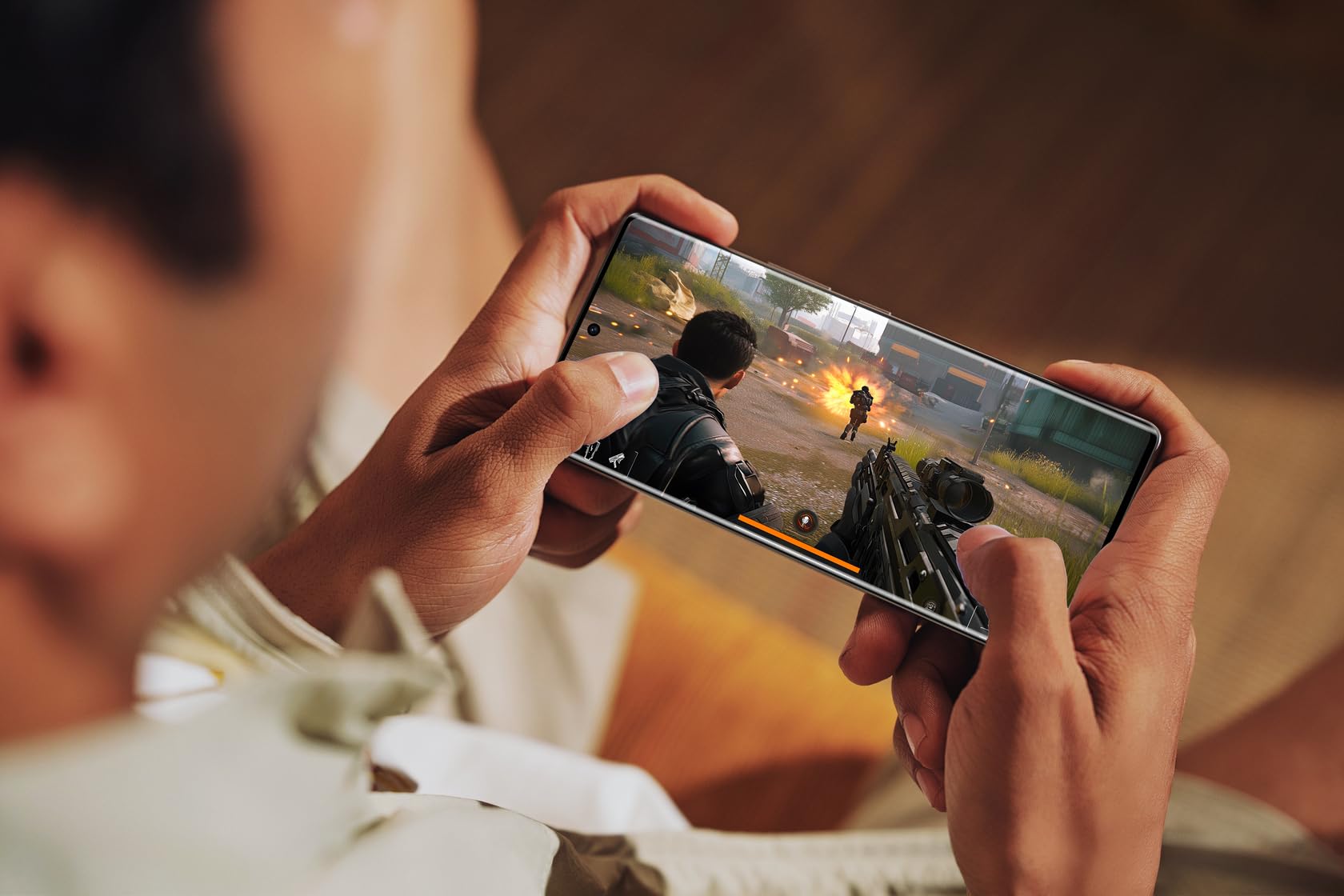 a man playing games with the Infinix Note 50s 5G - XPRS Egypt