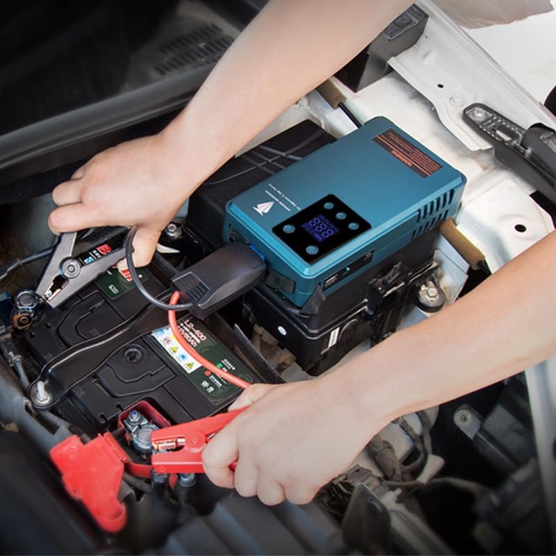 Person connecting jump starter clamps to a car battery