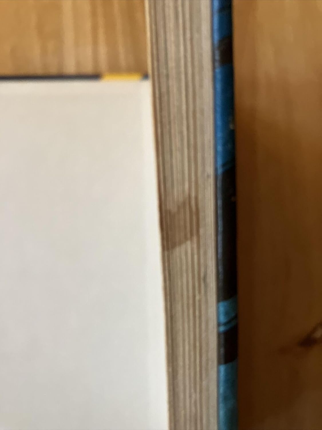 Side view of the Fiend Folio book, showing the spine and pages, indicating its thickness and binding.