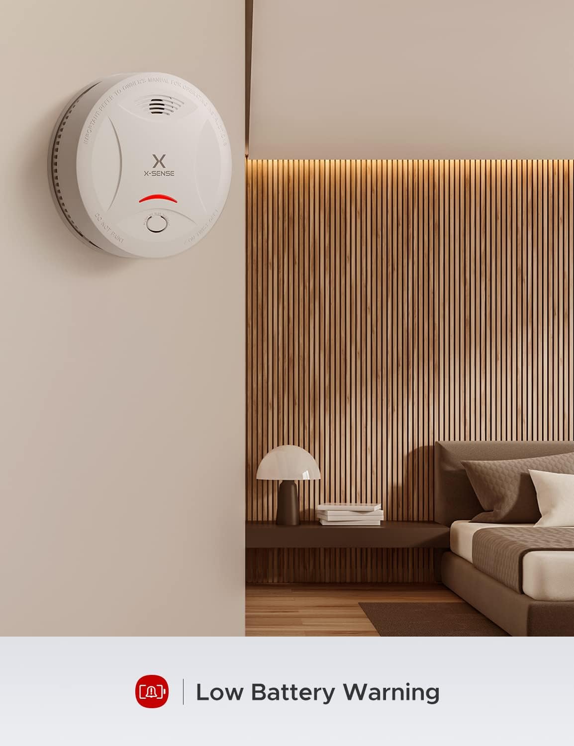A person pressing the test button on the X-Sense SD13 smoke detector mounted on a wall.