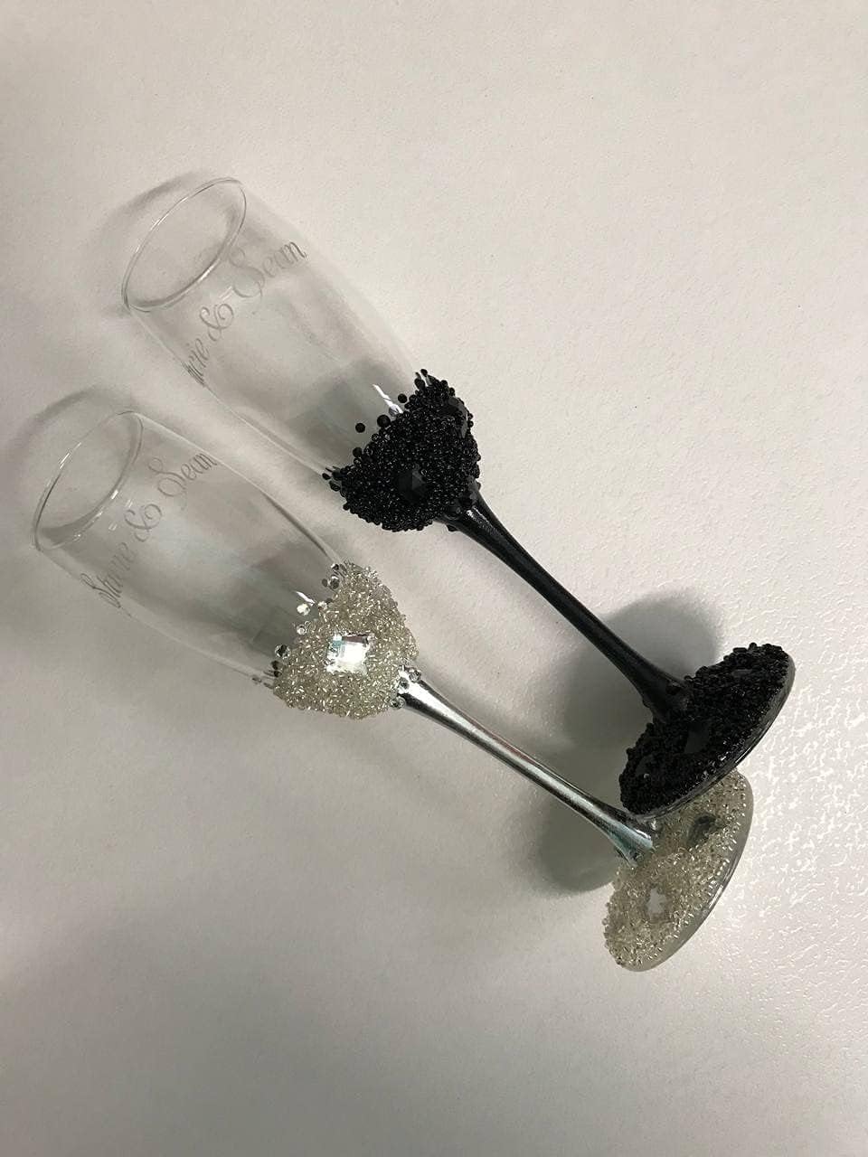 Personalized silver and black wedding flutes decorated with silver crystals