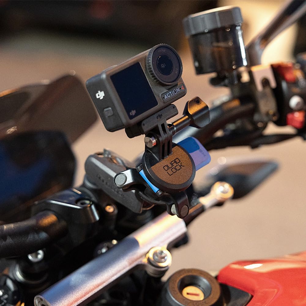 Quad Lock Action Camera Adapter Kit mounted on a motorcycle handlebar with an action camera