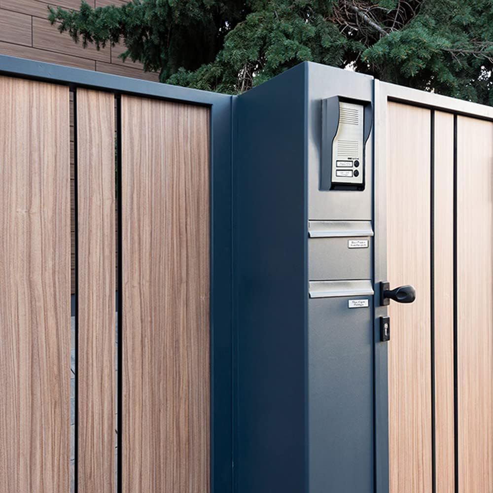 SCS Sentinel outdoor street plate mounted on a gate post next to a wooden gate, demonstrating a typical installation scenario.