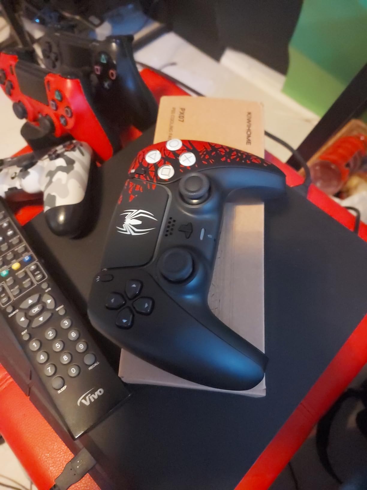 It has a ps5 controller and a code to get the spiderman 2 game on October 20th