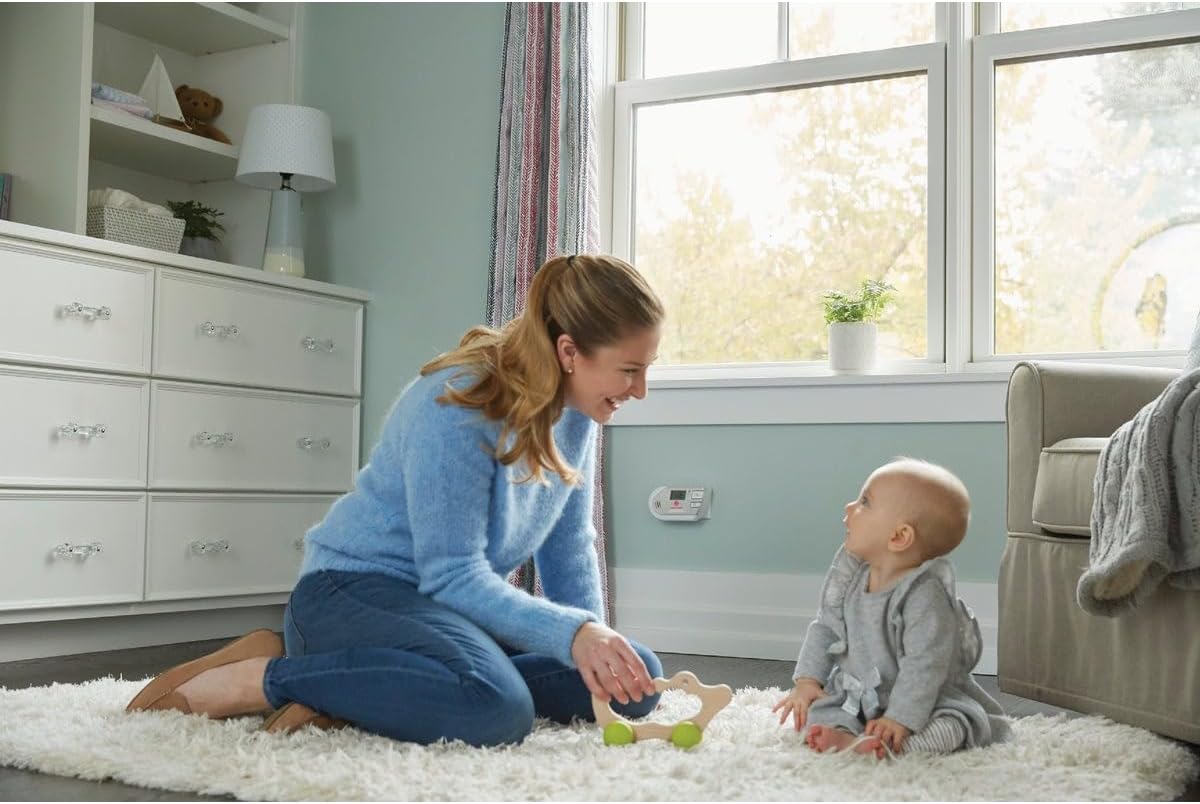Man plugging in the First Alert GCO1CN alarm into a wall outlet