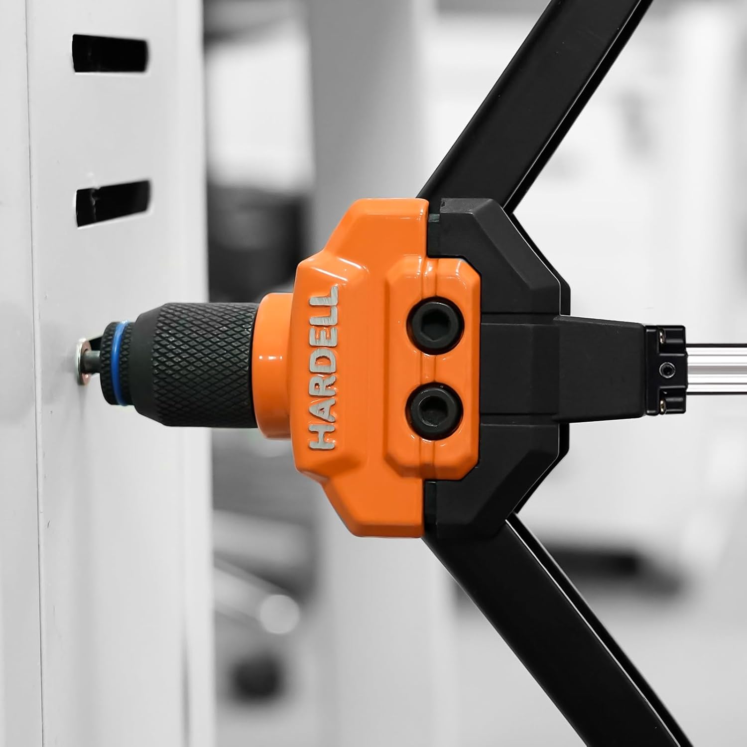 Close-up of the rivet nut tool in action, setting a rivet nut into a metal surface