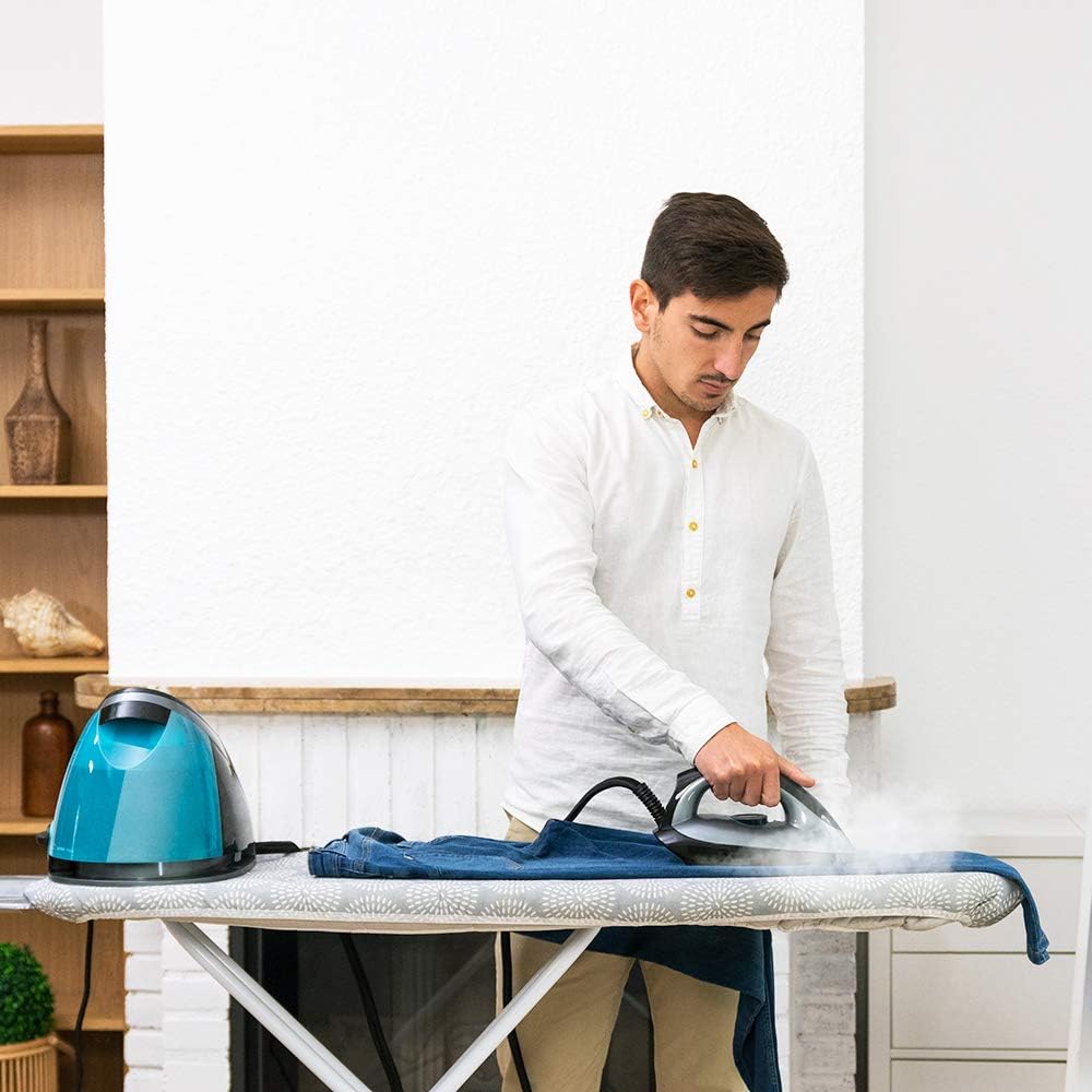 Person ironing clothes with steam iron