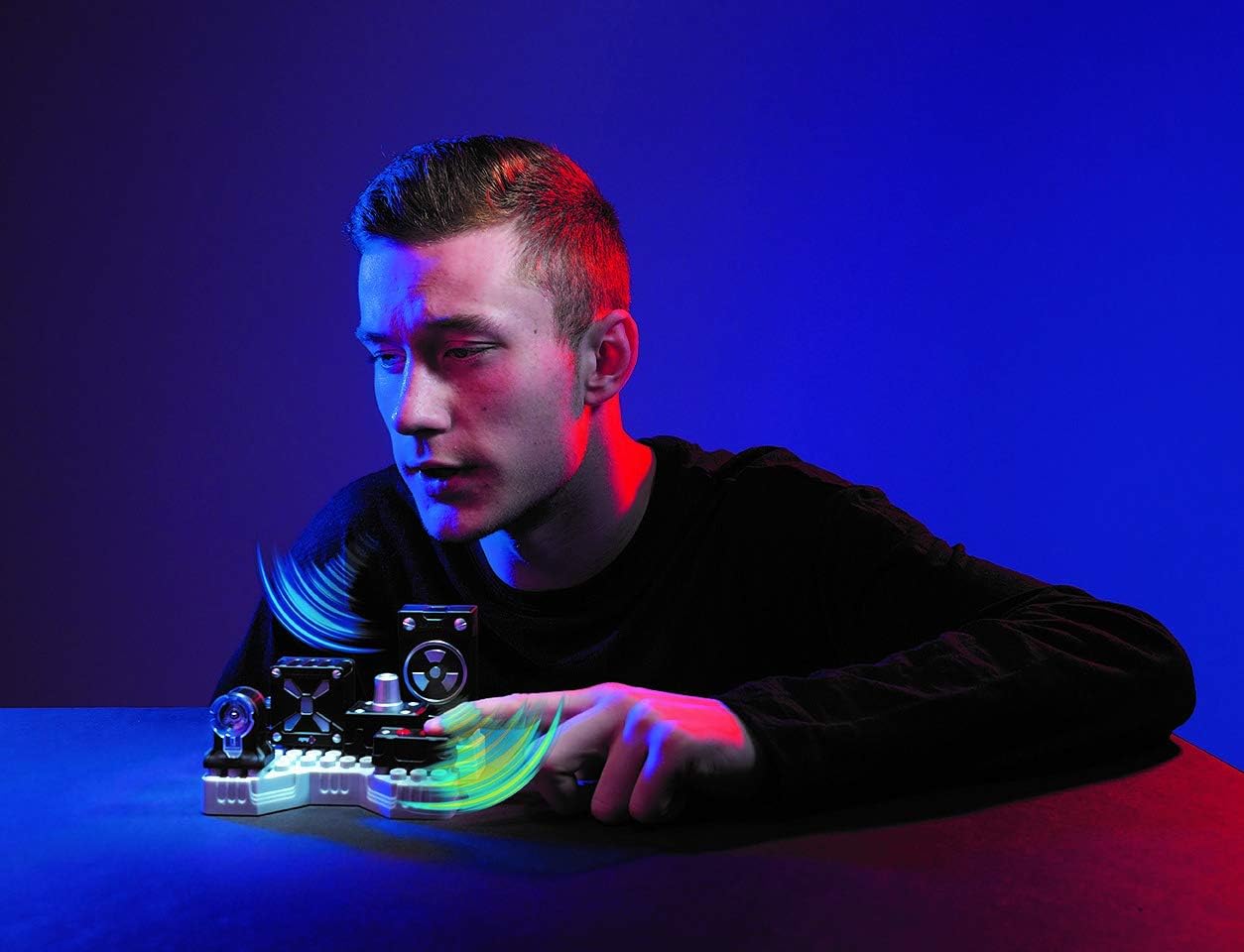 A person interacting with the assembled SpyX DIY Voice Disguiser, adjusting a knob.