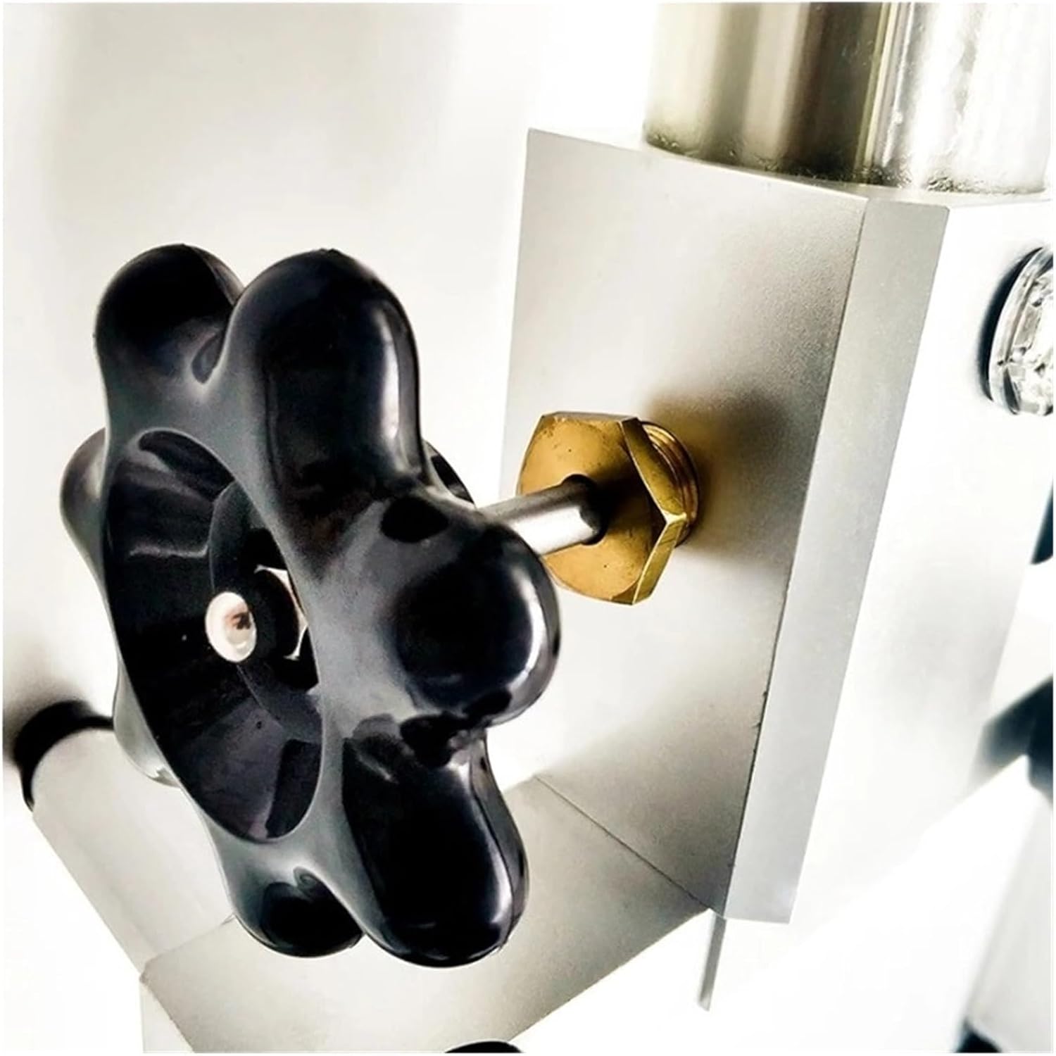 Close-up of a black adjustment knob on the hydraulic pump
