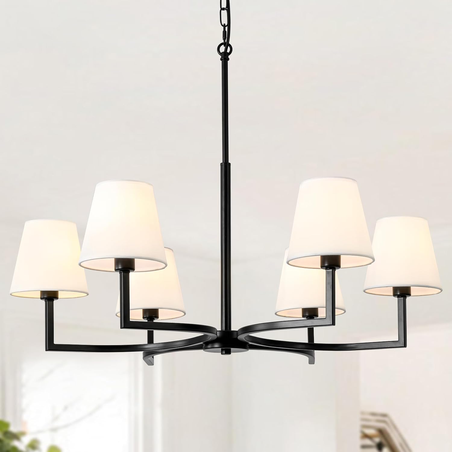 ASHUAQI chandelier installed in a spacious living room with light-colored decor